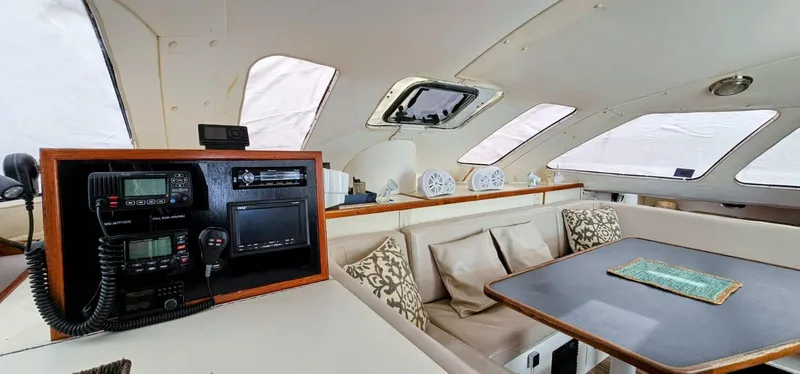  Yacht Photos Pics Interior of a 1994 Lagoon 42 catamaran with navigation equipment and seating area.