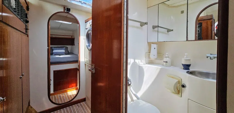  Yacht Photos Pics Interior of 1994 Lagoon 42 yacht showing bathroom and cabin with wooden accents.