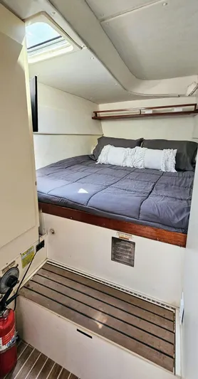  Yacht Photos Pics Cozy cabin interior of 1994 Lagoon 42 yacht with bed and wooden accents.