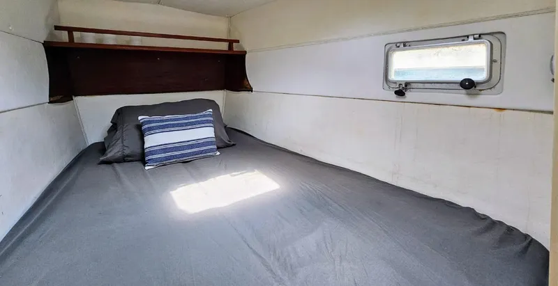  Yacht Photos Pics Cozy cabin interior of 1994 Lagoon 42 yacht with bed and window.