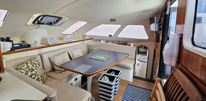  Yacht Photos Pics Interior of a 1994 Lagoon 42 yacht with cozy seating and dining area.