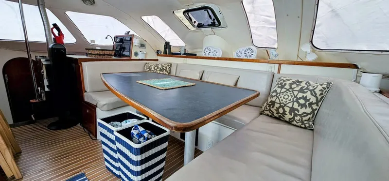  Yacht Photos Pics Interior of a 1994 Lagoon 42 yacht with cozy seating and a dining table.