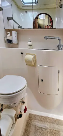  Yacht Photos Pics Bathroom interior of a 1994 Lagoon 42 yacht, featuring a toilet and sink.