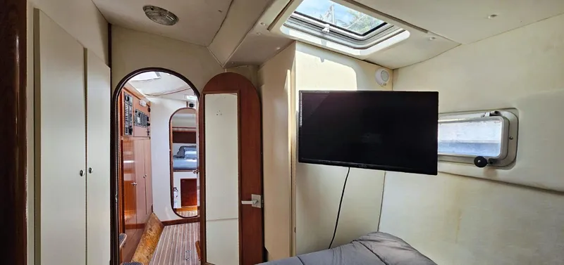  Yacht Photos Pics Interior of 1994 Lagoon 42 yacht with TV, skylight, and wooden accents.