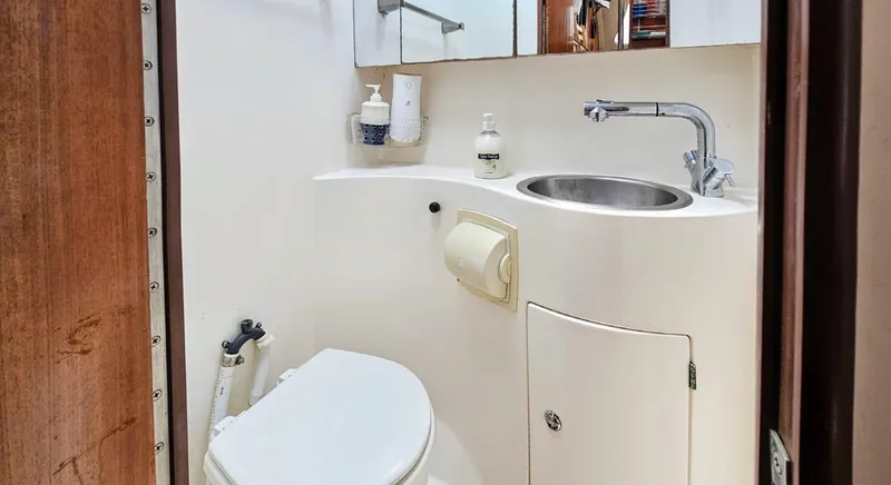  Yacht Photos Pics Bathroom interior of a 1994 Lagoon 42 yacht, featuring a compact sink and toilet.