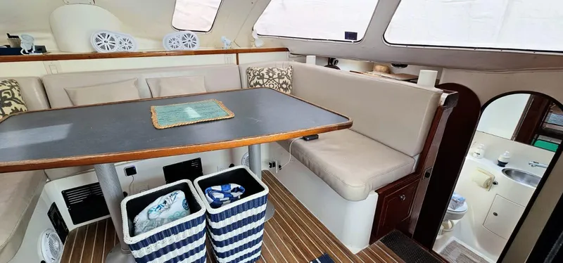  Yacht Photos Pics Interior of 1994 Lagoon 42 yacht with dining area and striped baskets.