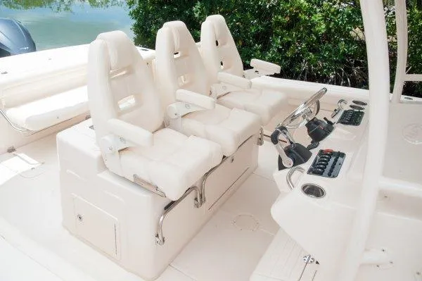  Yacht Photos Pics Manufacturer Provided Image: 2016 Grady-White Canyon 336 boat cockpit with three white captain's chairs and control panel.