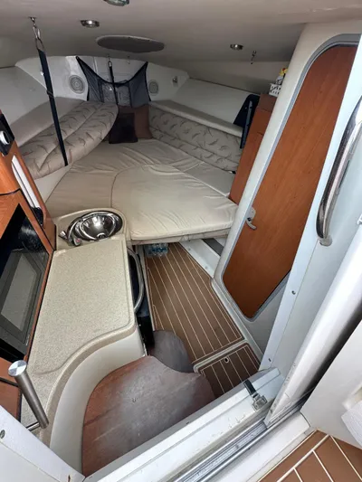  Yacht Photos Pics 2006 Hydra-Sports 2900 VX cabin interior with bed, kitchenette, and wooden flooring.