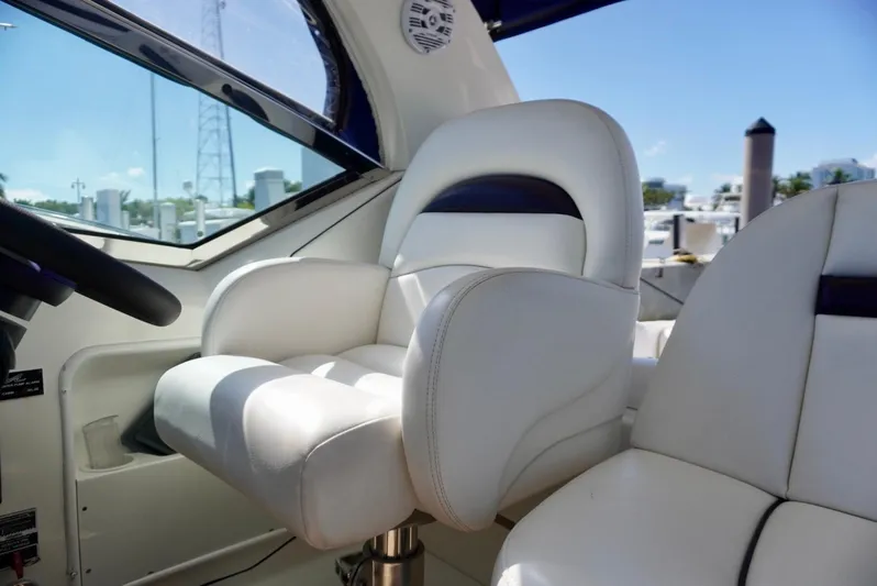  Yacht Photos Pics Captain's chair on 2007 Sea Ray 38 Sundancer yacht, featuring luxurious white upholstery.