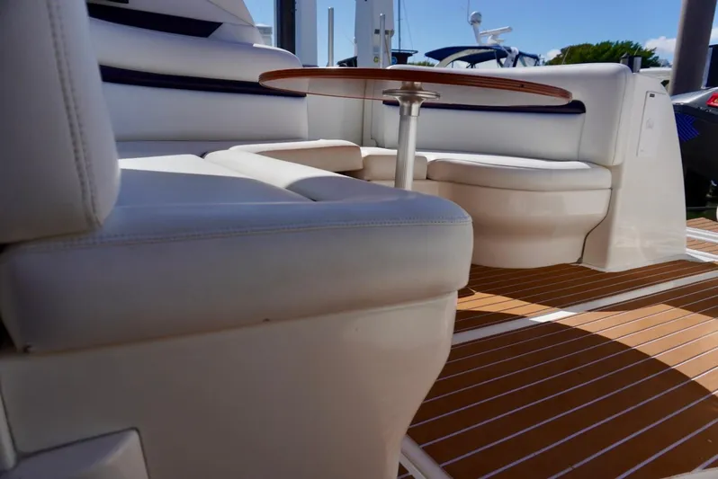  Yacht Photos Pics Interior seating area of 2007 Sea Ray 38 Sundancer with wooden flooring and round table.