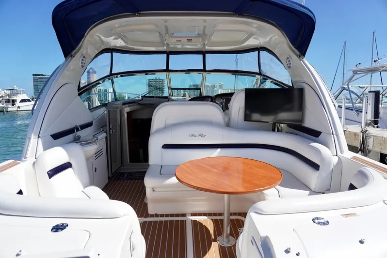  Yacht Photos Pics 2007 Sea Ray 38 Sundancer yacht interior with seating and table, docked at marina.