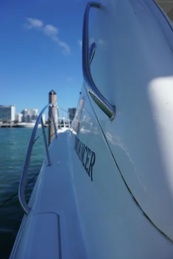  Yacht Photos Pics 2007 Sea Ray 38 Sundancer yacht side view with railing, docked by the water.