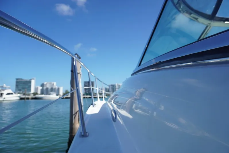  Yacht Photos Pics 2007 Sea Ray 38 Sundancer yacht docked with city skyline in background.