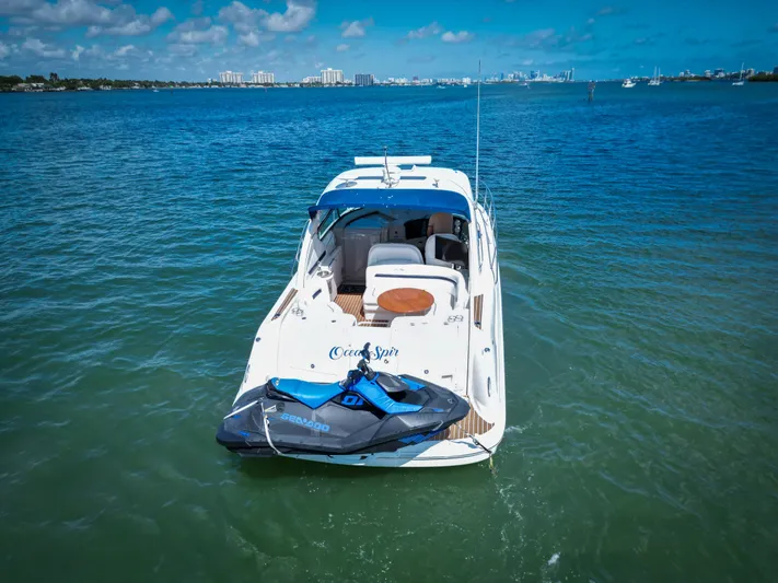  Yacht Photos Pics 2007 Sea Ray 38 Sundancer yacht with jet ski on calm blue water.