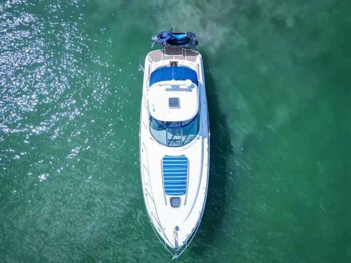  Yacht Photos Pics Aerial view of 2007 Sea Ray 38 Sundancer yacht on clear green water.