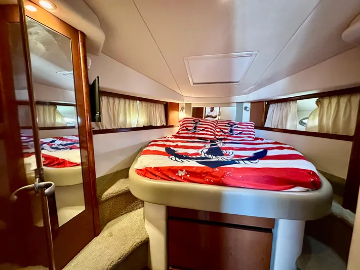  Yacht Photos Pics Luxurious cabin interior of 2007 Sea Ray 38 Sundancer with nautical-themed bedding.