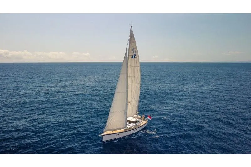  Yacht Photos Pics 2023 Hallberg-Rassy 50 sailing yacht on open sea under clear skies.