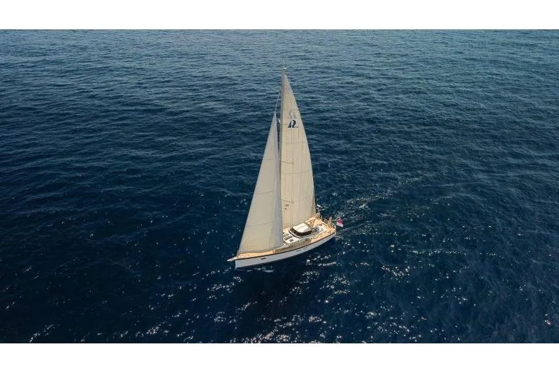  Yacht Photos Pics 2023 Hallberg-Rassy 50 sailing yacht on open sea, aerial view.