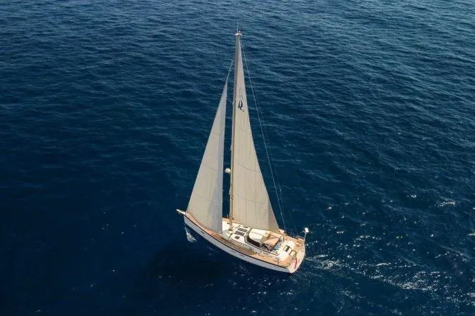  Yacht Photos Pics 2023 Hallberg-Rassy 50 sailing yacht on open sea, aerial view.