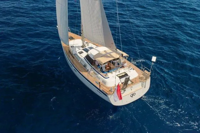  Yacht Photos Pics 2023 Hallberg-Rassy 50 sailing yacht on open sea, aerial view.