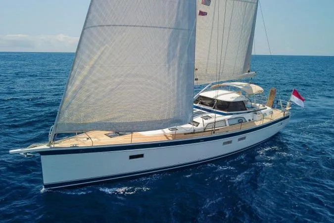  Yacht Photos Pics 2023 Hallberg-Rassy 50 sailing yacht on open sea with full sails.