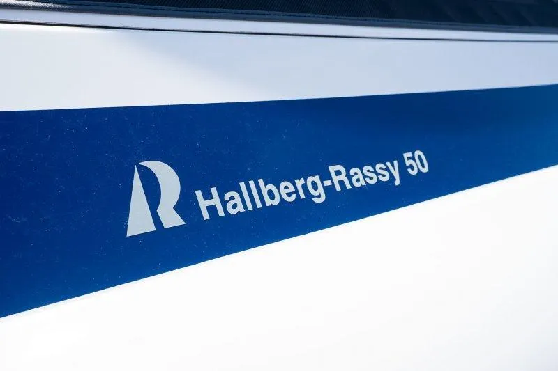 Yacht Photos Pics 2023 Hallberg-Rassy 50 yacht logo on blue and white background.