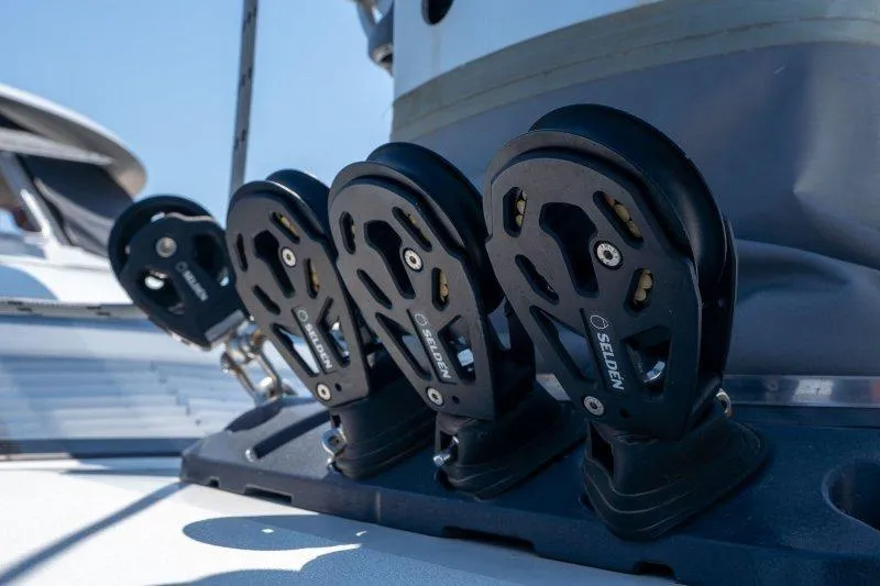  Yacht Photos Pics Close-up of 2023 Hallberg-Rassy 50 yacht rigging components under clear blue sky.