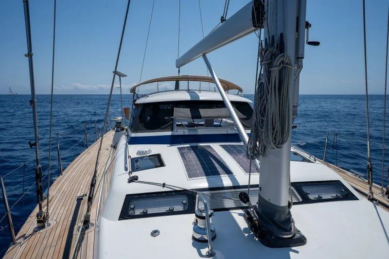  Yacht Photos Pics 2023 Hallberg-Rassy 50 yacht sailing on open sea, showcasing sleek deck design.
