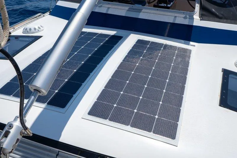  Yacht Photos Pics 2023 Hallberg-Rassy 50 yacht with solar panels on deck, sailing in sunny weather.