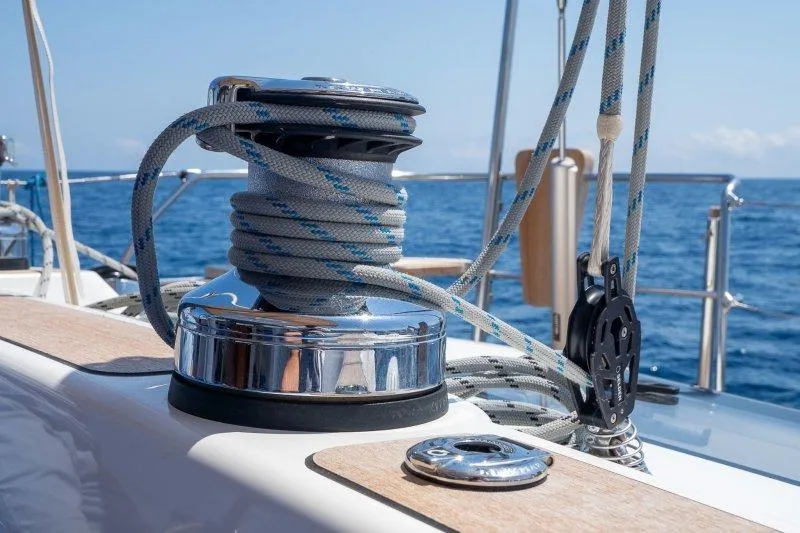  Yacht Photos Pics Close-up of a 2023 Hallberg-Rassy 50 yacht winch with ropes against ocean backdrop.