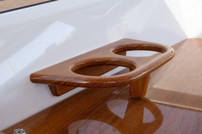  Yacht Photos Pics Wooden cup holder on 2023 Hallberg-Rassy 50 yacht, showcasing elegant craftsmanship.