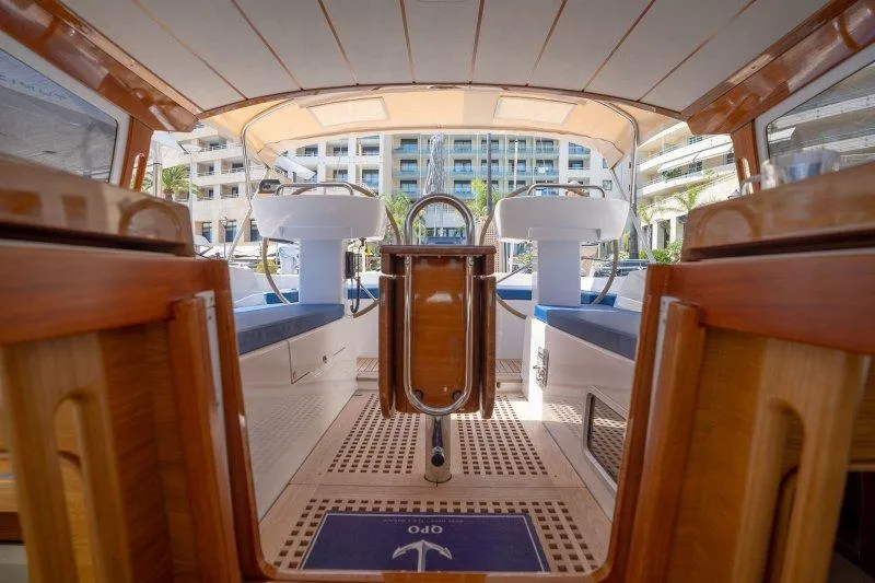  Yacht Photos Pics 2023 Hallberg-Rassy 50 yacht cockpit with elegant wood finish and modern design.