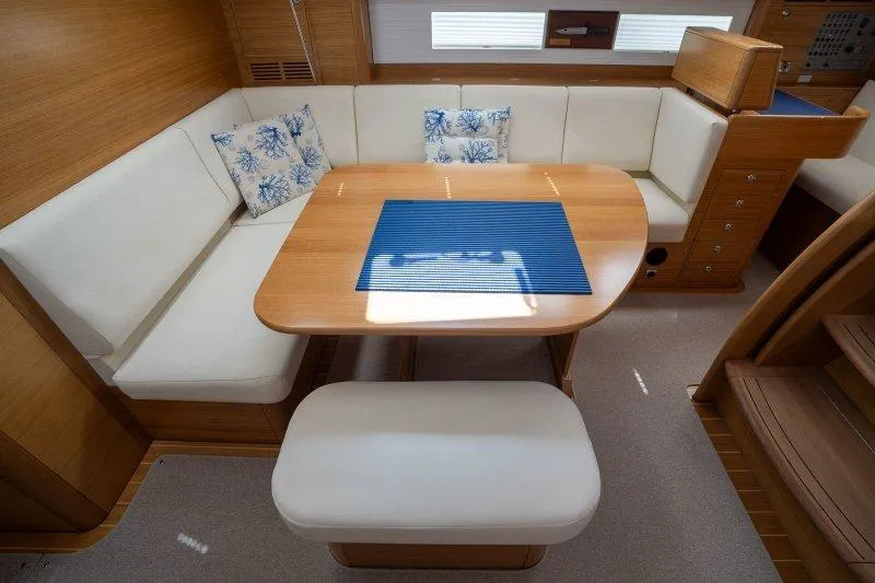  Yacht Photos Pics Luxurious 2023 Hallberg-Rassy 50 yacht interior with elegant dining area and plush seating.