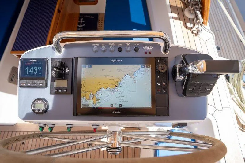  Yacht Photos Pics 2023 Hallberg-Rassy 50 yacht helm with navigation display and controls.