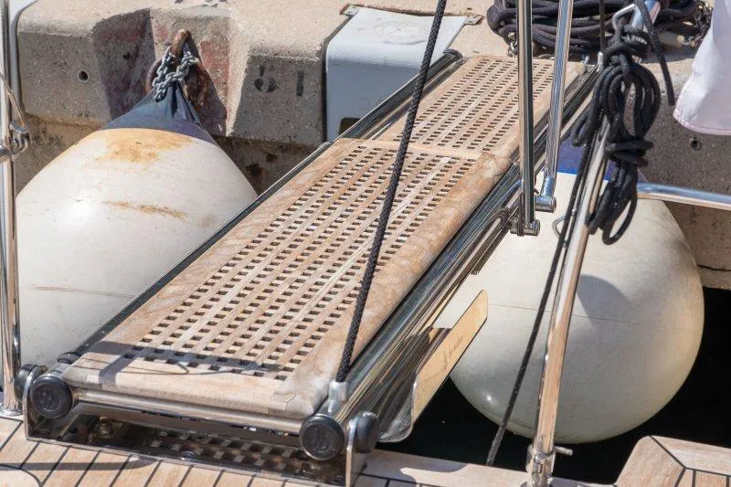  Yacht Photos Pics Gangway of 2023 Hallberg-Rassy 50 yacht with dock fenders in background.