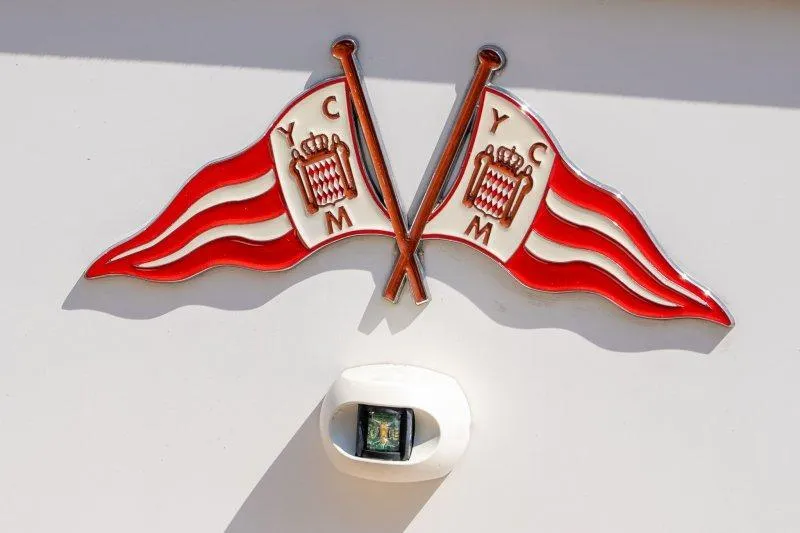  Yacht Photos Pics Emblem of crossed red and white flags on 2023 Hallberg-Rassy 50 yacht.