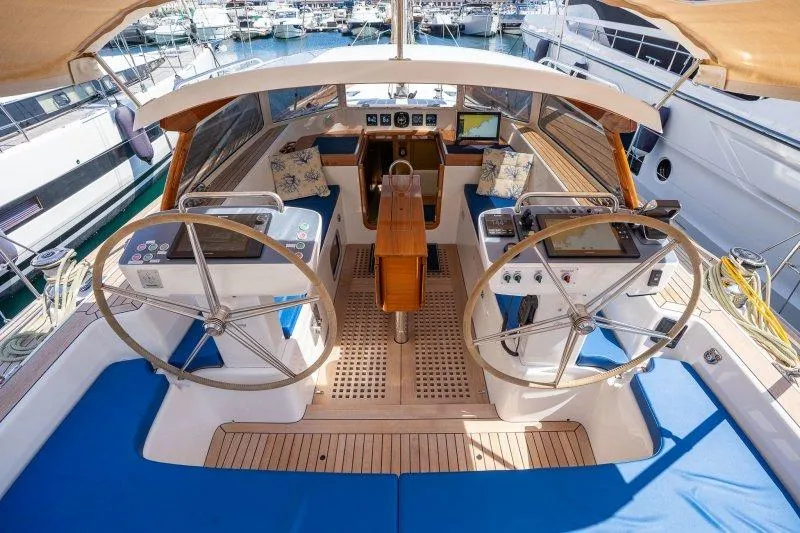  Yacht Photos Pics 2023 Hallberg-Rassy 50 yacht cockpit with dual steering wheels and navigation equipment.