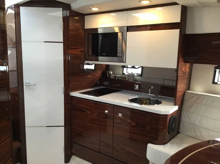  Yacht Photos Pics Luxurious interior of 2025 Cobrey 33 HT yacht with modern kitchen amenities.