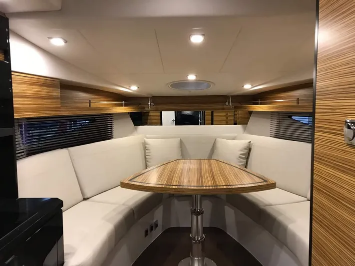  Yacht Photos Pics Luxurious interior of 2025 Cobrey 33 HT yacht with elegant wood and plush seating.