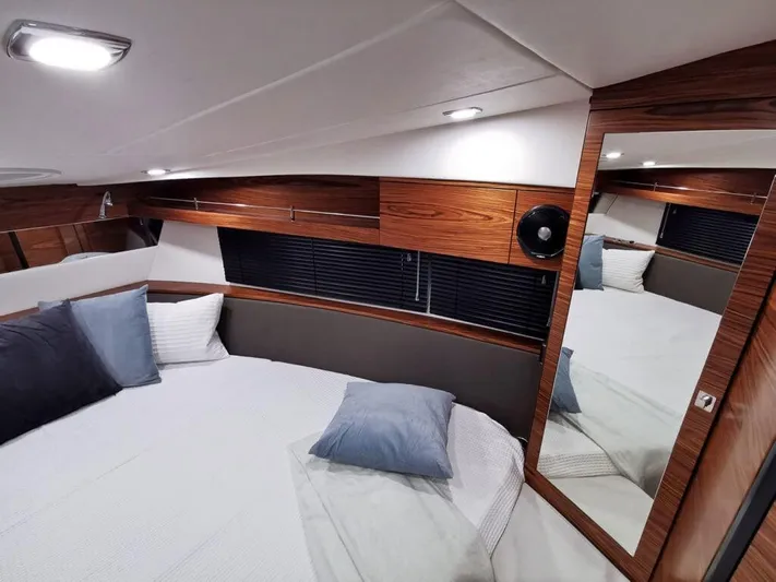  Yacht Photos Pics Luxurious cabin interior of 2025 Cobrey 33 HT yacht with modern wood finishes.
