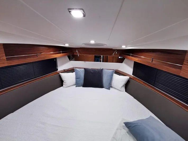  Yacht Photos Pics Luxurious interior cabin of 2025 Cobrey 33 HT yacht with modern bedding and wood accents.