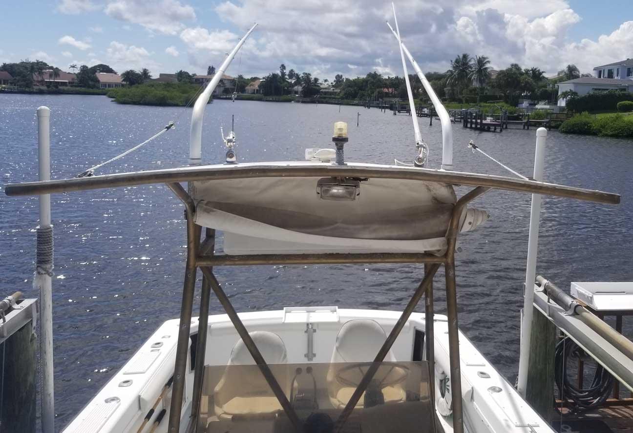 1977 Pace Wahoo boat docked on a sunny day, overlooking a calm waterway.