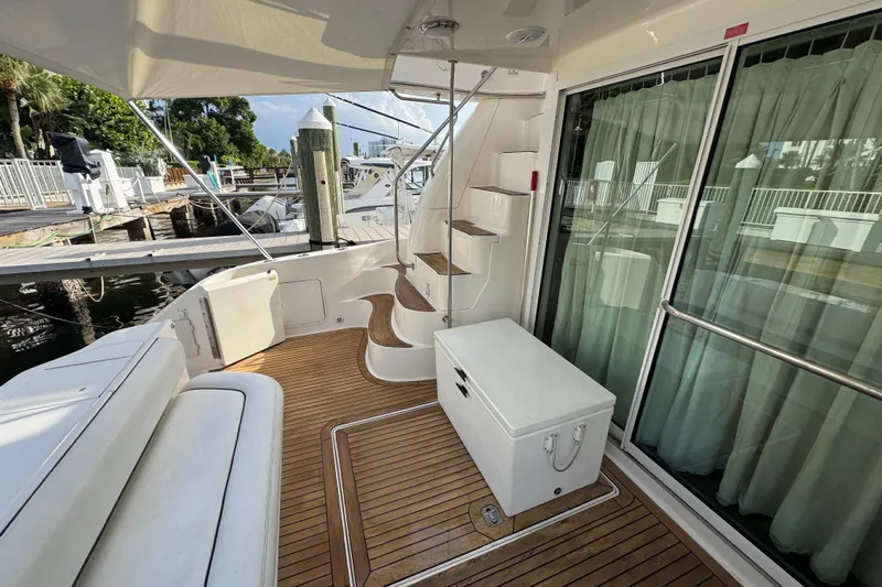 Scanner II Yacht Photos Pics 1998 Sea Ray 480 Sedan Bridge yacht deck with wooden flooring and staircase.