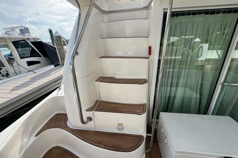 Scanner II Yacht Photos Pics Staircase on 1998 Sea Ray 480 Sedan Bridge yacht with wooden steps and railing.