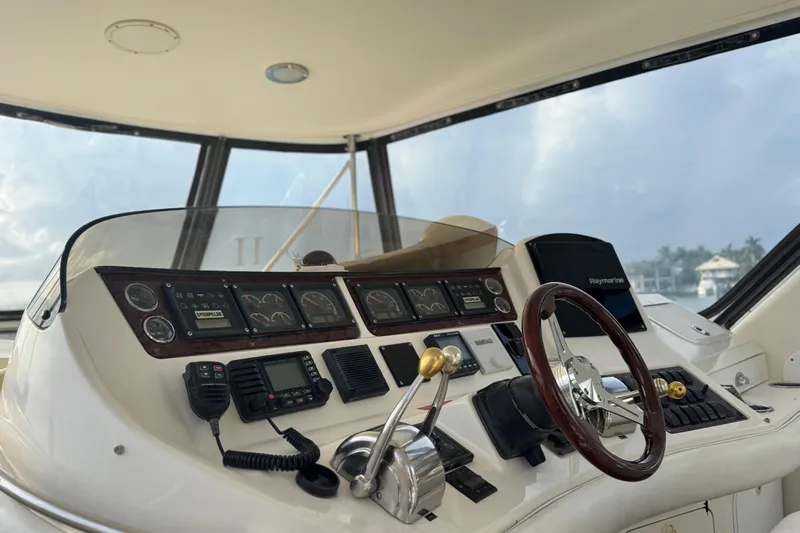 Scanner II Yacht Photos Pics 1998 Sea Ray 480 Sedan Bridge helm with gauges, controls, and Raymarine navigation system.