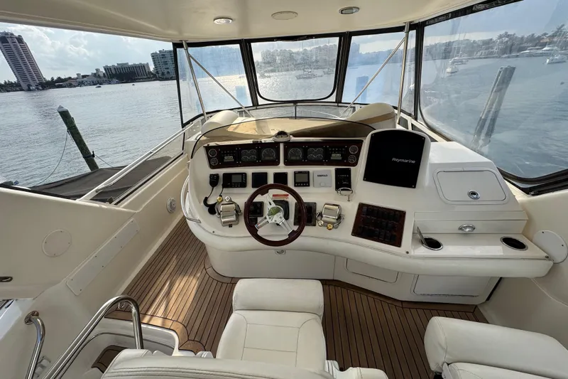 Scanner II Yacht Photos Pics 1998 Sea Ray 480 Sedan Bridge helm with panoramic water view and modern controls.
