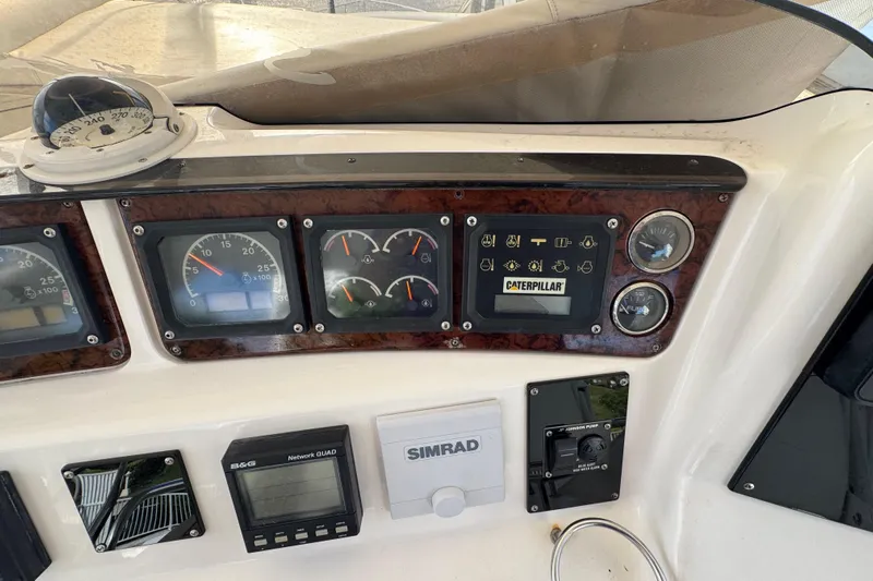 Scanner II Yacht Photos Pics Control panel of a 1998 Sea Ray 480 Sedan Bridge with gauges and navigation equipment.