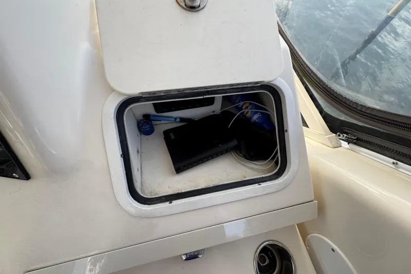 Scanner II Yacht Photos Pics Storage compartment on a 1998 Sea Ray 480 Sedan Bridge boat, containing various items.