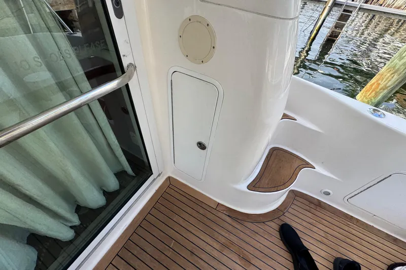 Scanner II Yacht Photos Pics 1998 Sea Ray 480 Sedan Bridge yacht deck with wooden flooring and railing.