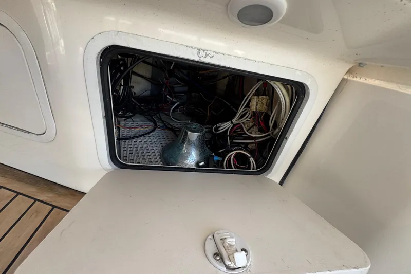 Scanner II Yacht Photos Pics Access panel on a 1998 Sea Ray 480 Sedan Bridge, revealing internal wiring and components.